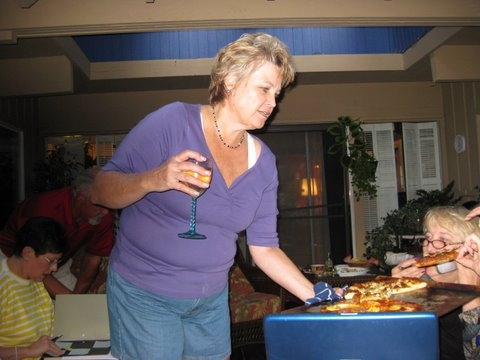 Lauri Hein, doing what she does best, serving pizza and drinking wine.