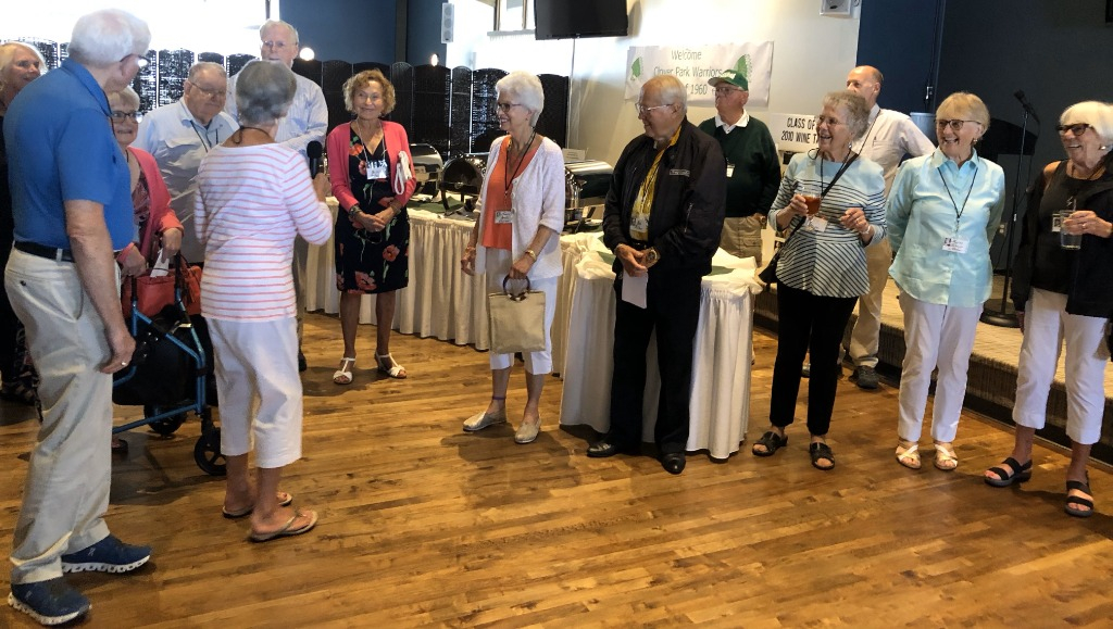 Group talking with Roberta on microphone.
