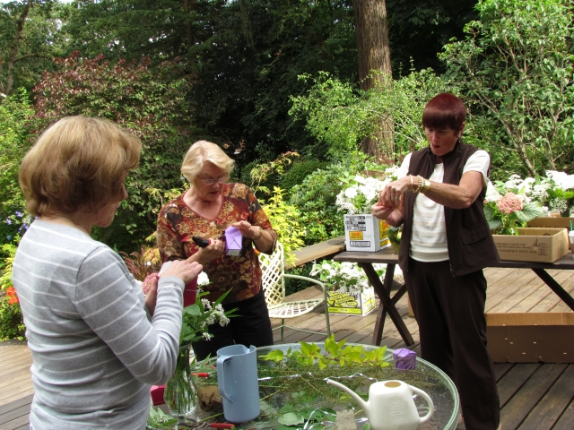 Karen Kasemeier Patton, Sandy Torfin Bassett, and Jane Pauley making flower decorations