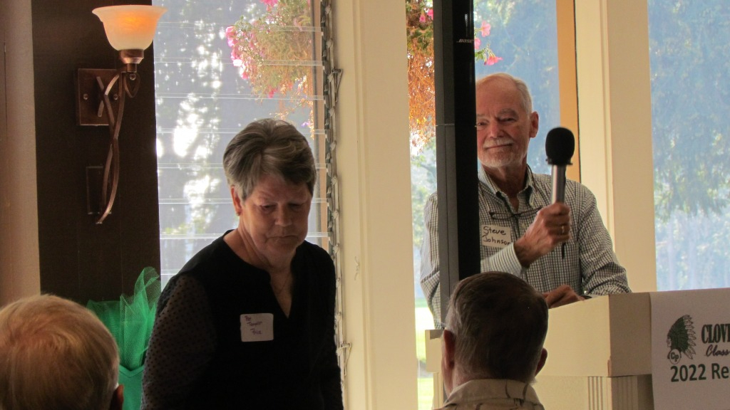 Master of Ceremonies Steve Johnson at the microphone with Pat Templin Price