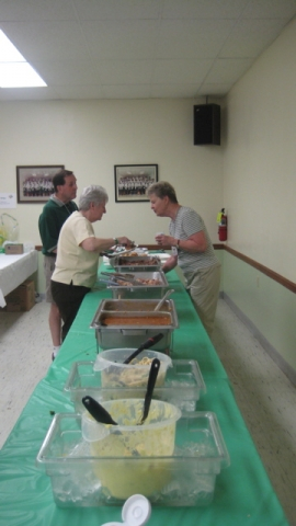 Nancy Dutro Thompson 59 (on right) makes sure the serving line is ready to go.