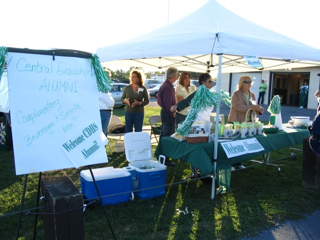 The Alumni Welcome Booth greets our CD grads as they enter the game.
