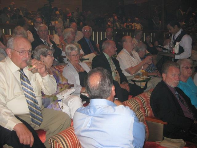 The group gathers in the theater for the evenings show,and of course, another cocktail!