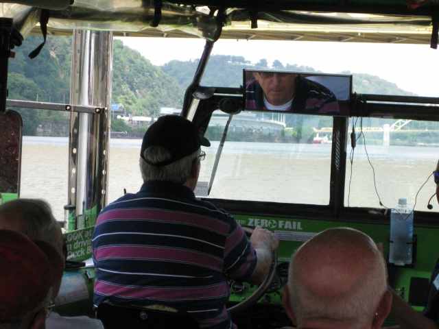 Jack Agnew 65 takes the helm of the duck boat on the river.