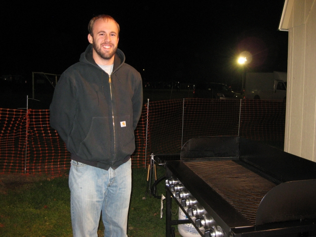 Our expert grill master - Nick Evans 06. Not pictured: Assistant Griller, Sam Potteiger 58. The pre-game grillers are Gary Wierman 76 and Gary Smitty Smith.