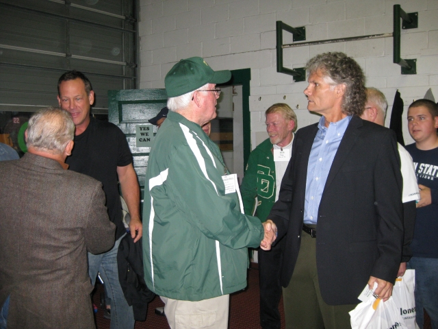 Earl Stepp 73 (back to camera) greets Mike Byrnes 73, Coach Terry King greets Kevin Maronic 73.  Bob Trea 74 in CD Varsity Jacket.