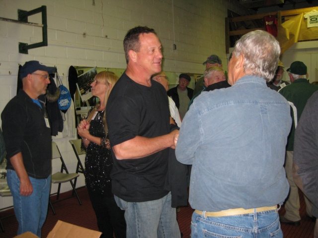 Max Smith 73 chats with Brenda Foreman Messina 73.  Mike Byrnes 73 talks with Coach Dick Shiffert.