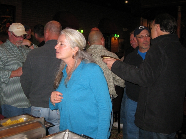 Lori Kilby Shook 75 checks out the food provided by the Alumni Association.