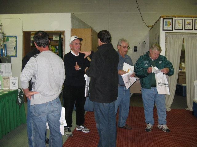 Coaches, players & cheerleaders arrive and pick up their Welcome Packets.