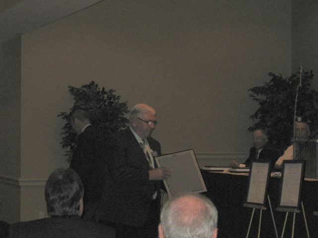 Barry accepts his award.