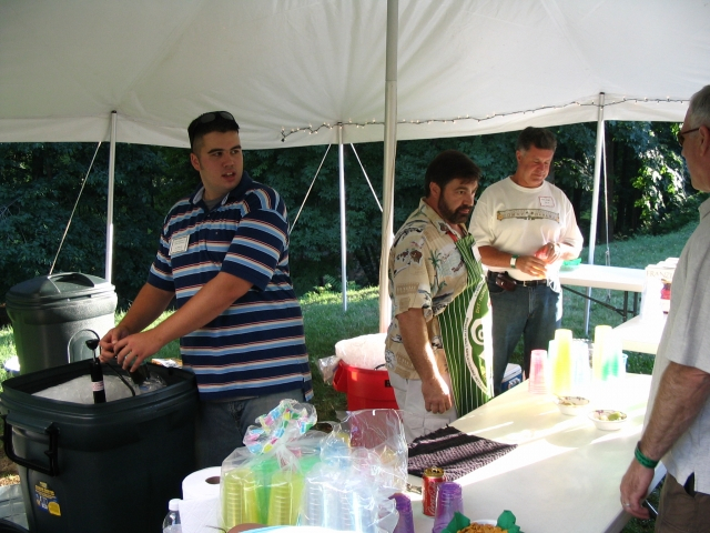 AJ Dewey, Class of 04, and John Suszko serve beverages.