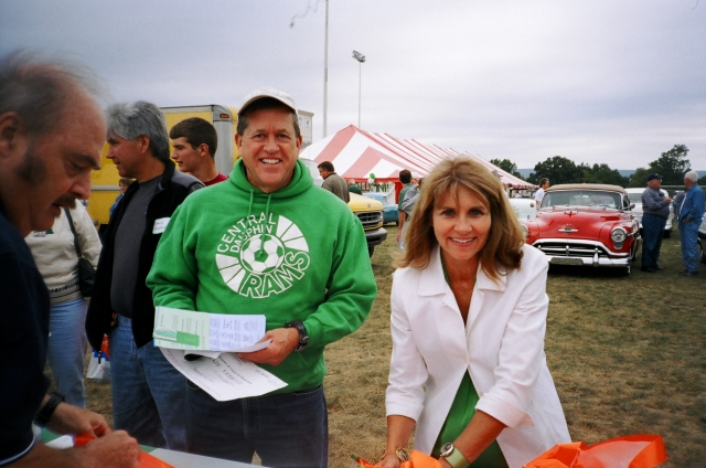 Jan Gardner Suszko, Class of 69, and Ted Kreider work on registration of the more than 70 cars entered in the Car Parade.