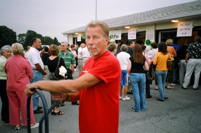 Herb Wragg, Class of 58, lends a hand with moving supplies and drinks from the school cafeteria to the football field.