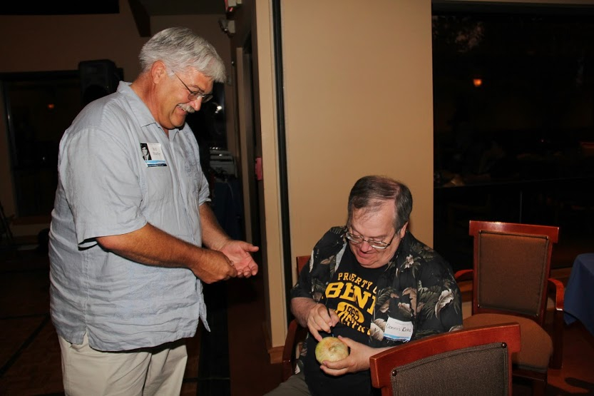 Bill Shaffer, Dennis Koho signing a commemorative onion.