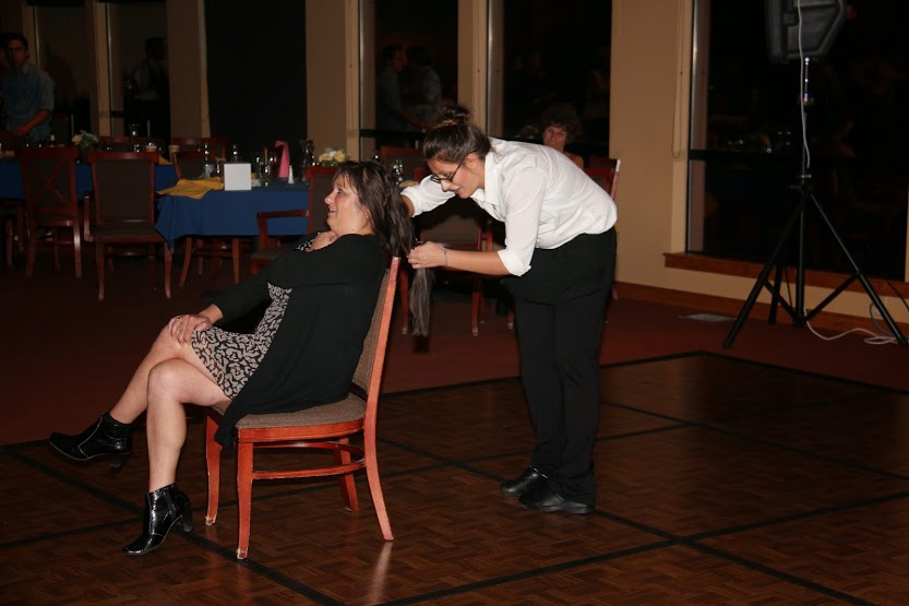 Bend Golf Clubs Banquet Manager making a donation to Locks of Love.