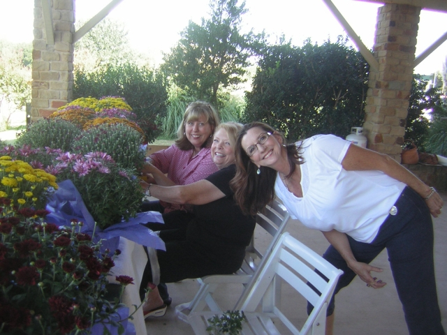 Decorating the mum centerpieces:  Donna Ashford, Susan Starnes, and Joy Bowman.