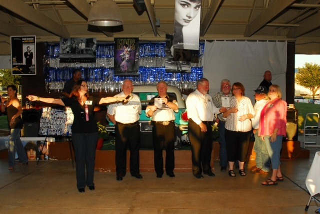 Joy Bolman trying to lead the former band members as the school Alma Mater is sung.