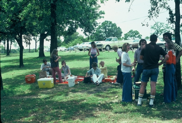 (029) 1975 Reunion Picnic Event: Foreground group... Gary Sibley (stripe shirt), Annette DeSalvo (Orange), Sherry Hill (white blouse). Background group... Paula Mikel (yellow), Kathy Vernon (purse searching), Judi Waters (sipping on an RC cola), Susan S