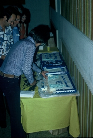 (015) 1975 Reunion Evening Event:  Cake Table... Carolyn Brown in the red dress at the far end of the table.