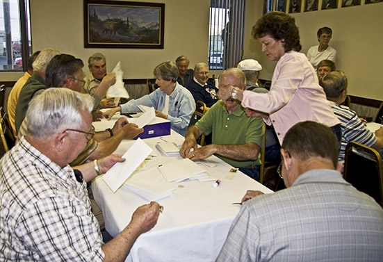 Labeling envelopes for 50th high school reunion information letters.