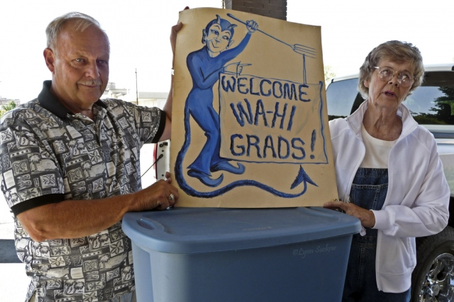 BobBruhjell and Ann Ray holding up an historical Blue Devils sign.