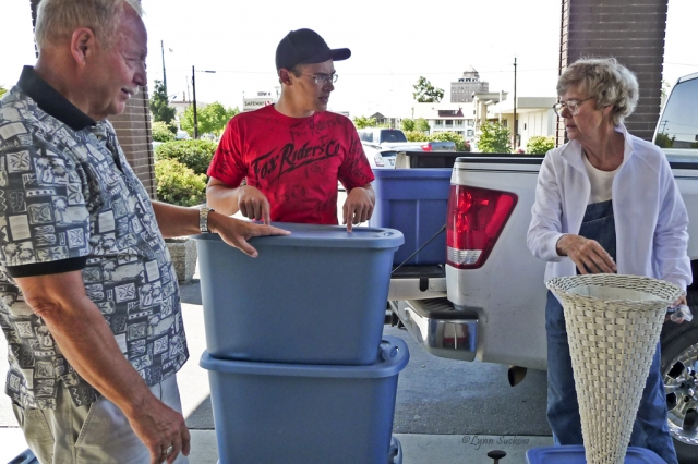 Bob Bruhjell and Grandson helping Ann Ray pack up the truck with memorabilia.