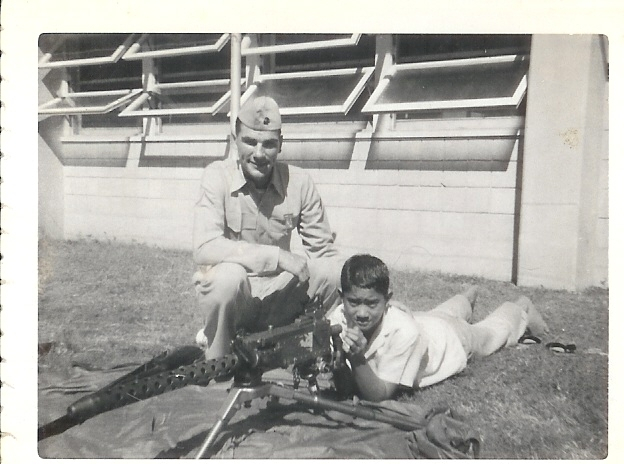 Gary Wolf demonstrating light machinegun to young enthusiast in Hawaii