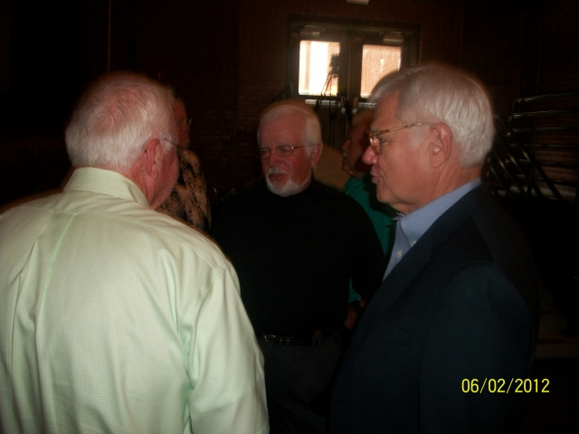 Emcee Jimmy Wallace talks with friends