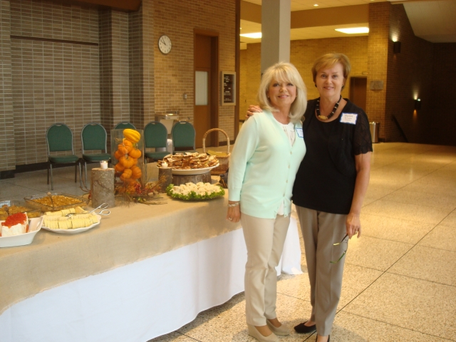 Ann McBride McDaniel and Harriet McHughes Johnson in front of the Brunch table