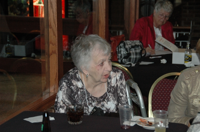 Judy Renner Higbee talks while in the background Dorothy Klinefelter keeps her nose to the grindstone
