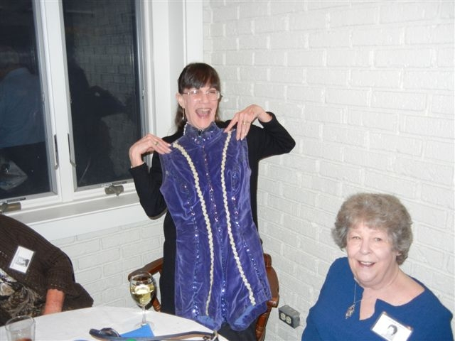 Kay Ann, It still fits! And Peggie Huie watches the unvailing of the majorette costume that Gayle Portwood has had in her attic for all these many years.