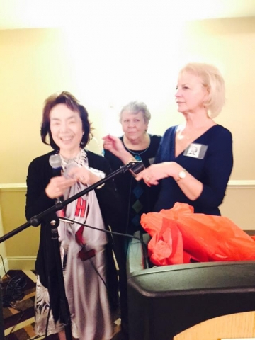 Mutsuko Suuchi Uehara receives gift of Red Sox jersey from Shirley Perkins Haynes and Marilyn Scola Bart.