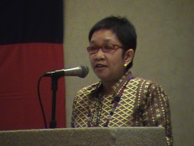 Dean Gigi de Asas Lunas turn at the podium for State of the College report. 
