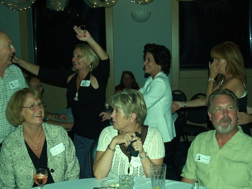 Carol Rose gets the dance strolling around the room. Seated is Connie Dean (68) wife of Steve Dean, Lynn Rutz, wife of Jim Rutz and Jeff Bowers.