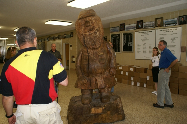 John Frenchs back, Mr. Haver, Sally (Mrs. Wayne)Sharum and John Stroh look at the big Reb.  Carved our senior year by Clarance Fell from a trunk cut and delivered by Kievel Weavers dad. 