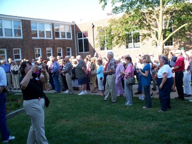 Peggy Willis Sherard (black shirt) taking picture at Shawnee Mission High School