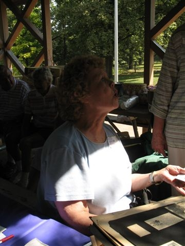 Sandy Grubb Chapman with Girl Scout scrapbook at Hickory Reunion