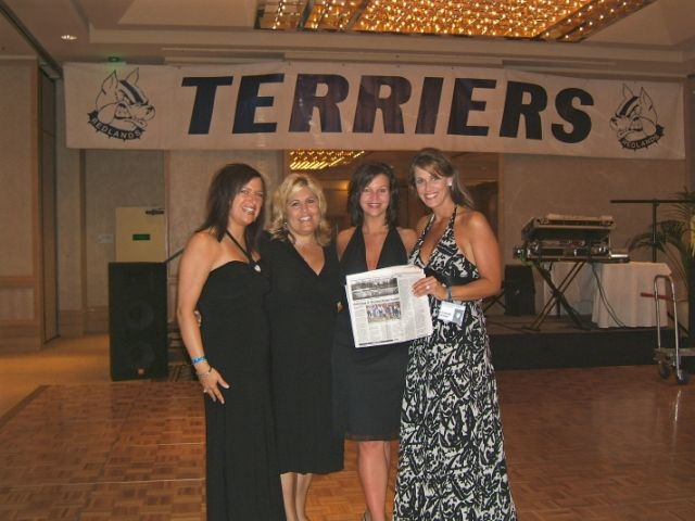 The reunion committee poses with the Redlands Daily Facts article about the reunion.