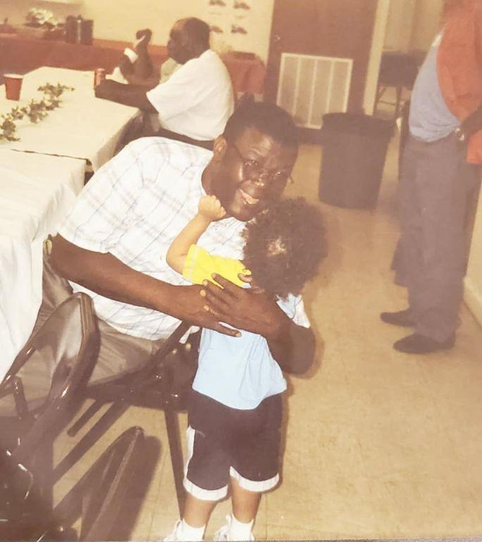 Clinton hugging and smiling for the camera with Lil Mack