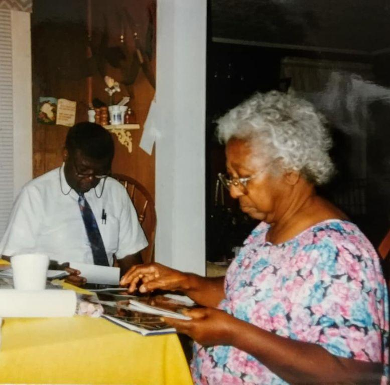 Clinton, looking down with Agnes looking at photo album