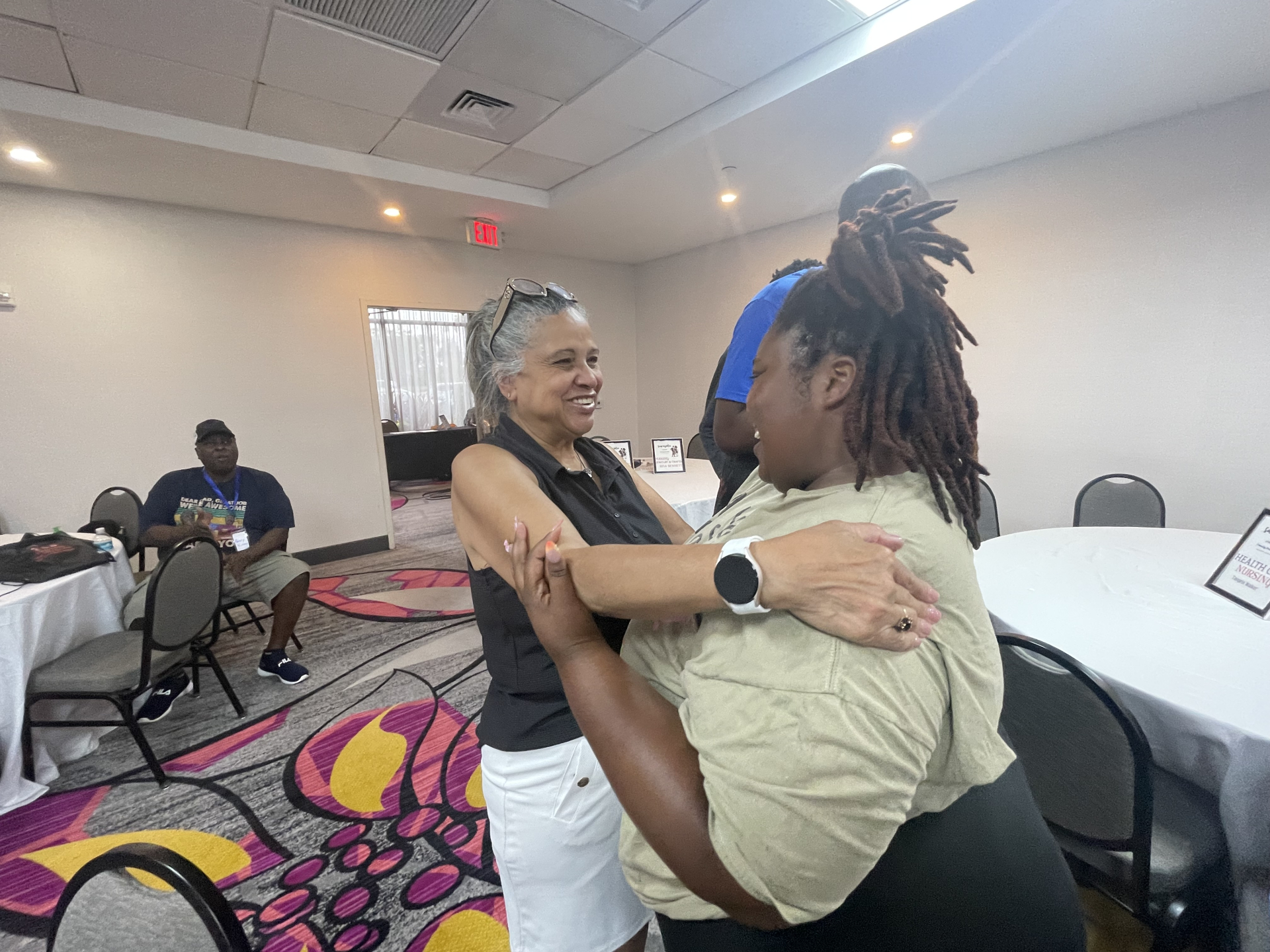 Rita Bennett and Michelle Kinsey hug at Meet and Greet