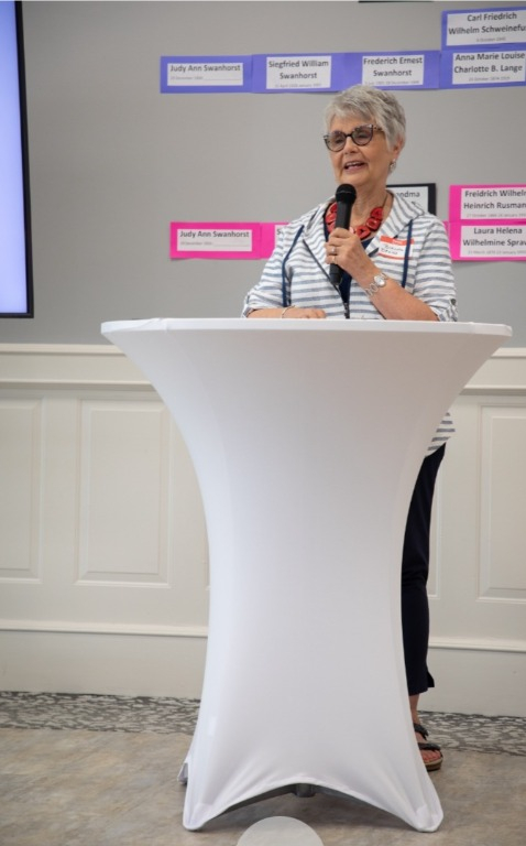 Brenda Bruns explaining significance of the table centerpieces filled with rock