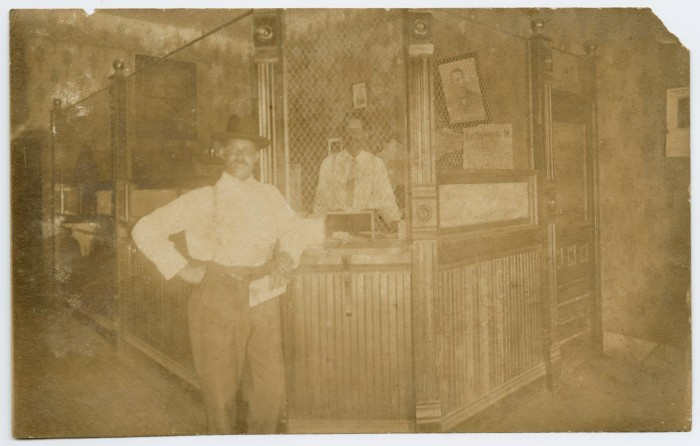 H.L. Price cashier inside Farmers & Citizens Savings Bank