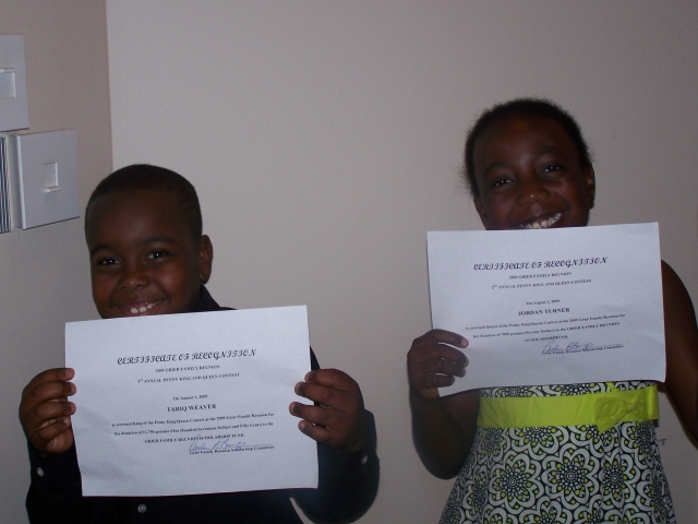 Tariq & Jordon display award for winning Penny King & Queen Contests.