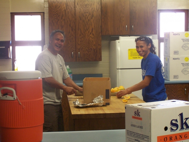 This is the second in command and the other Man of the Year, Henry (Nellies hard working husband) cutting oranges with Sarana>Alamoni (Maries youngest daughter) for the sports games/tug-o-war being held after lunch in the park. We couldnt have had this fa