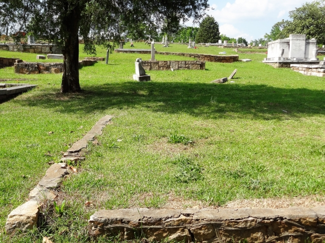 The family burial site has only a stone border with a few markers. But there is no headstone.