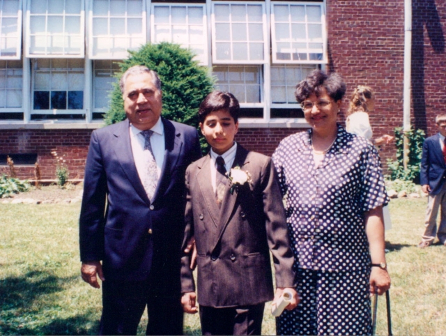 Raj and parents at grade school graduation