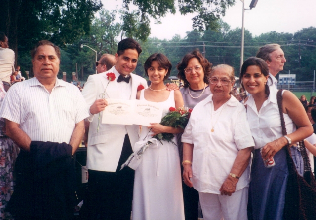 Raj with family and Shalini at his high school graduation