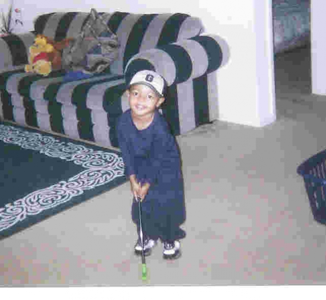 Miguel practicing golf at 3 years.