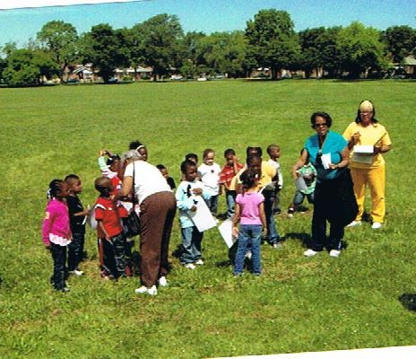 Grandma Ellis pinning Leroys ribbon on him as he recieve his Preschool Certificate. (June 9, 2010)
